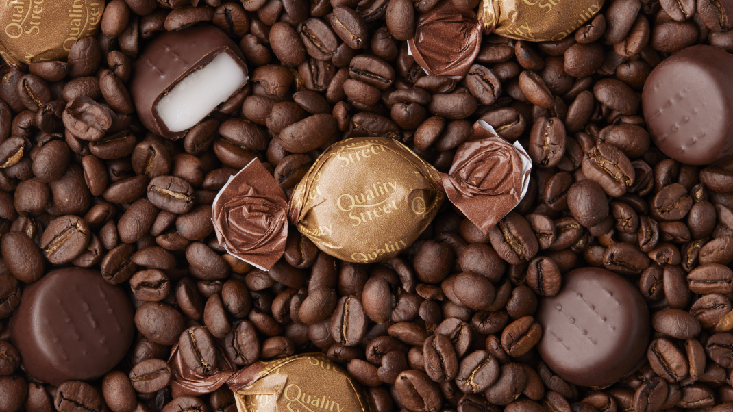 Coffee Creme Quality Street sweet on a bed of coffee beans