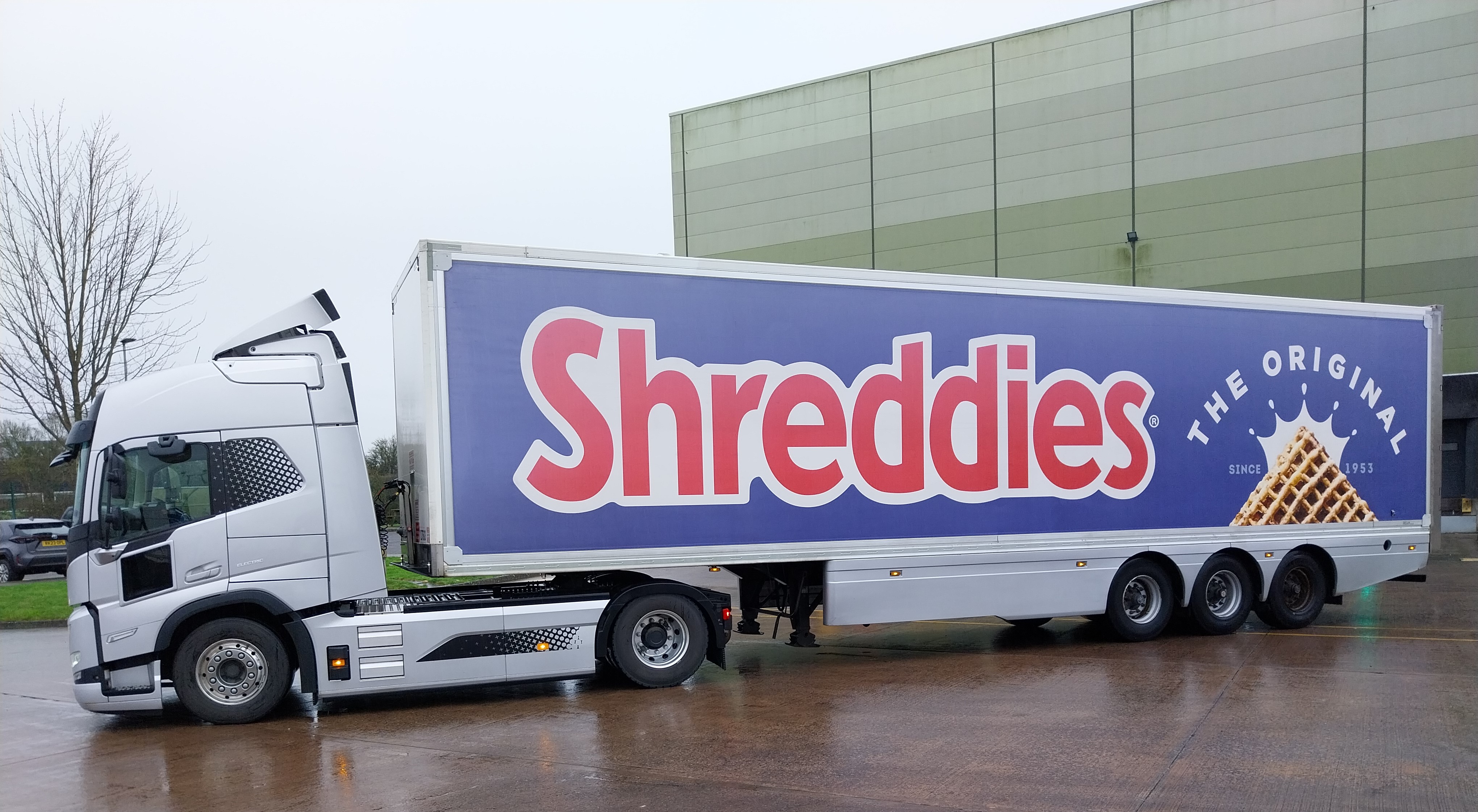 A white electric truck with Shreddies branding on the side of the vehicle. 