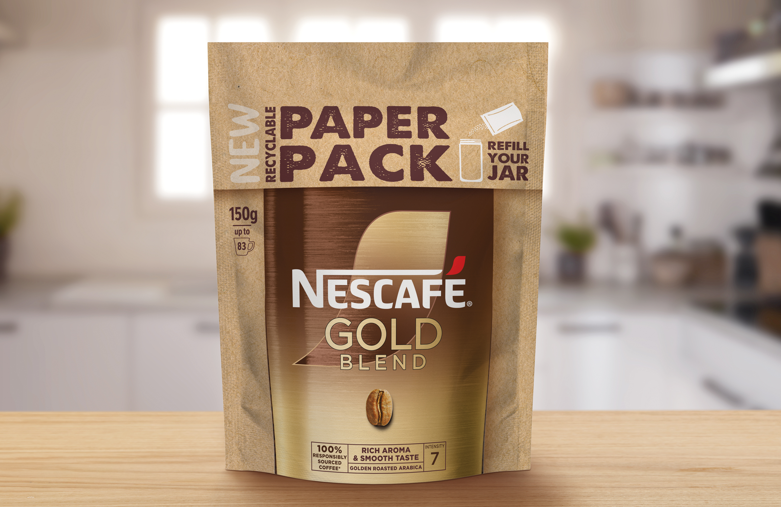 A paper pack of Nescafé Gold Blend coffee, on a light brown wooden kitchen surface.