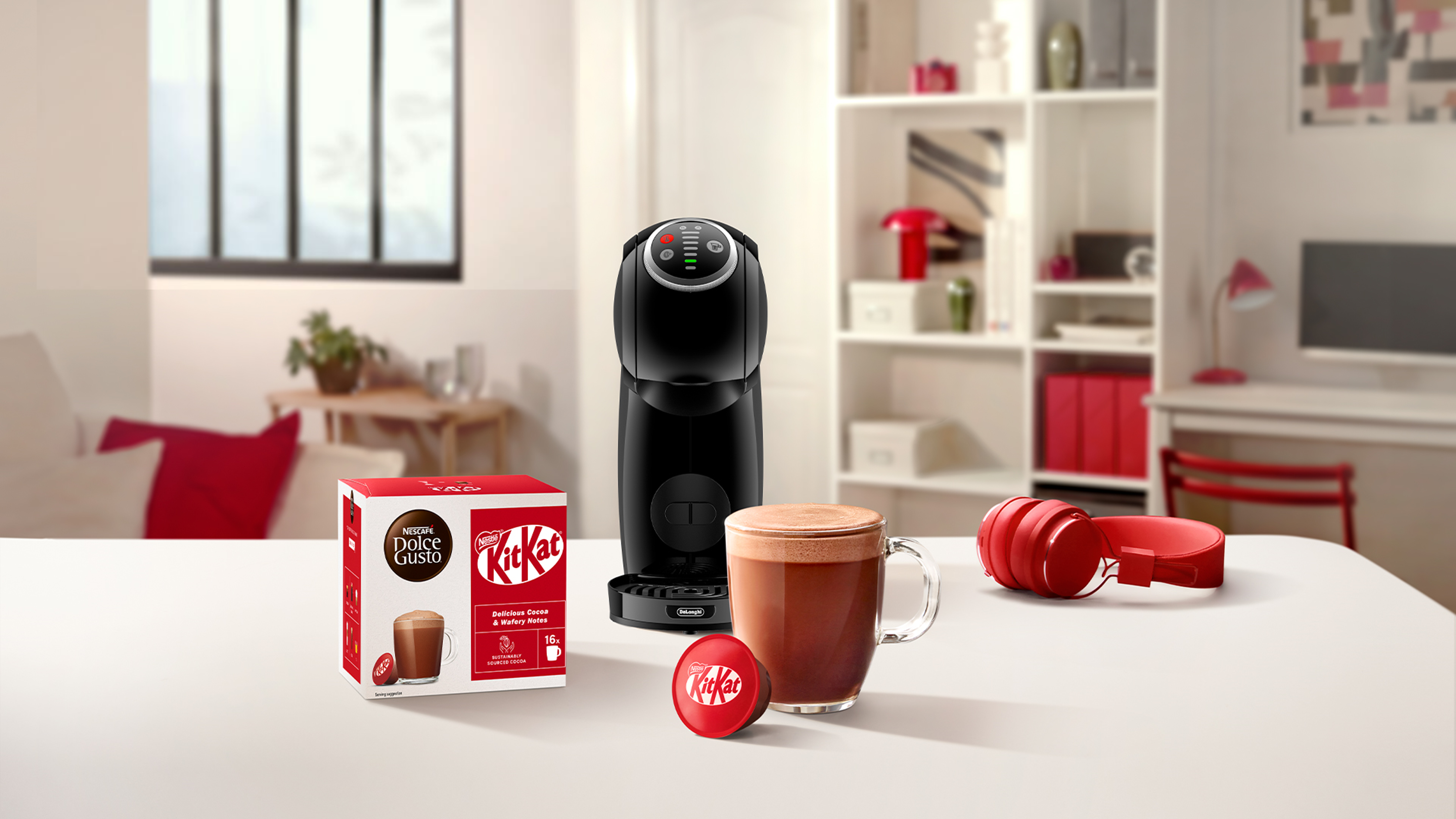 Nescafe Dolce Gusto KitKat Hot Chocolate in a mug next to a pod and coffee machine on a table
