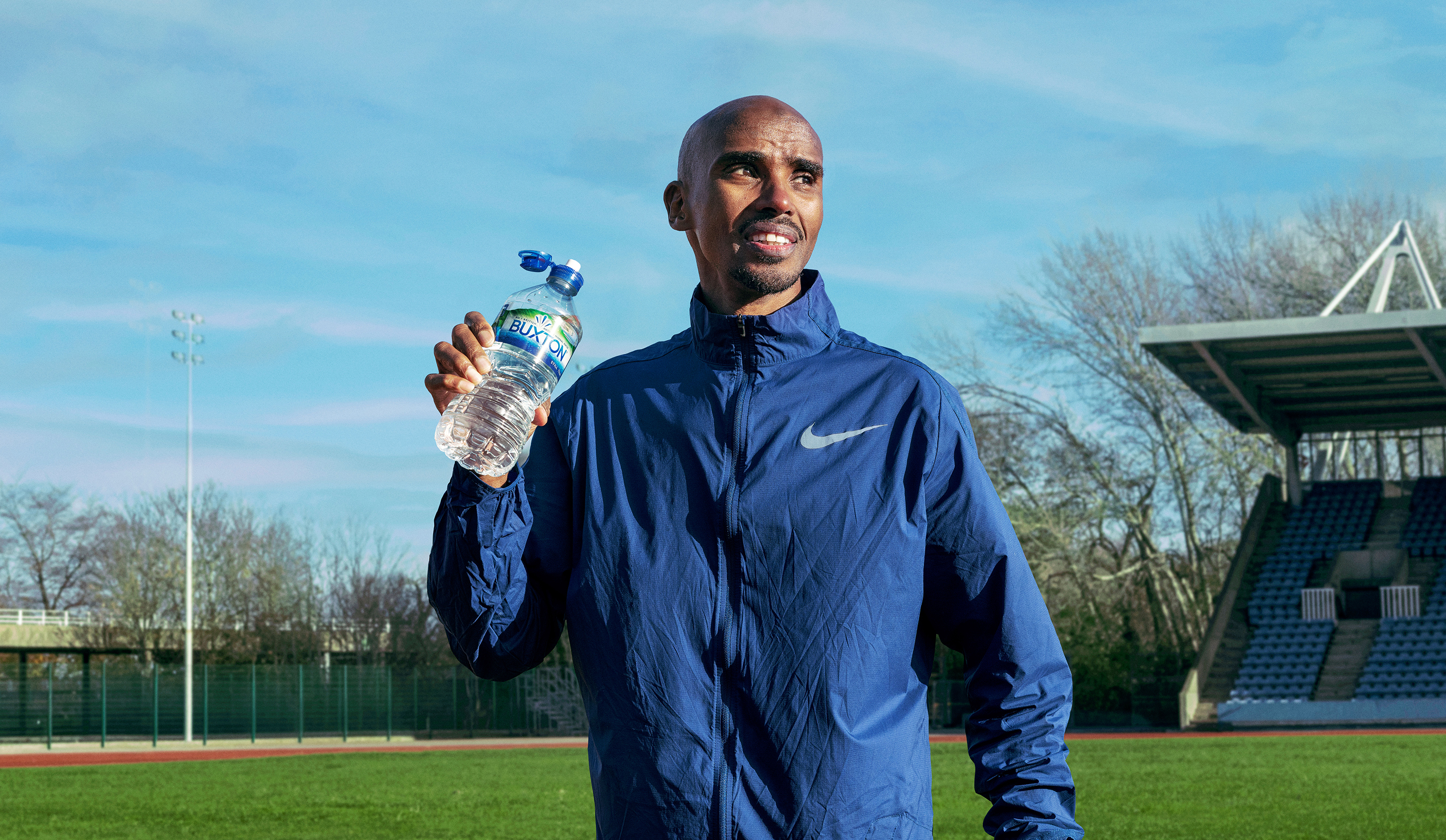 Mo Farah drinking a bottle of Buxton water