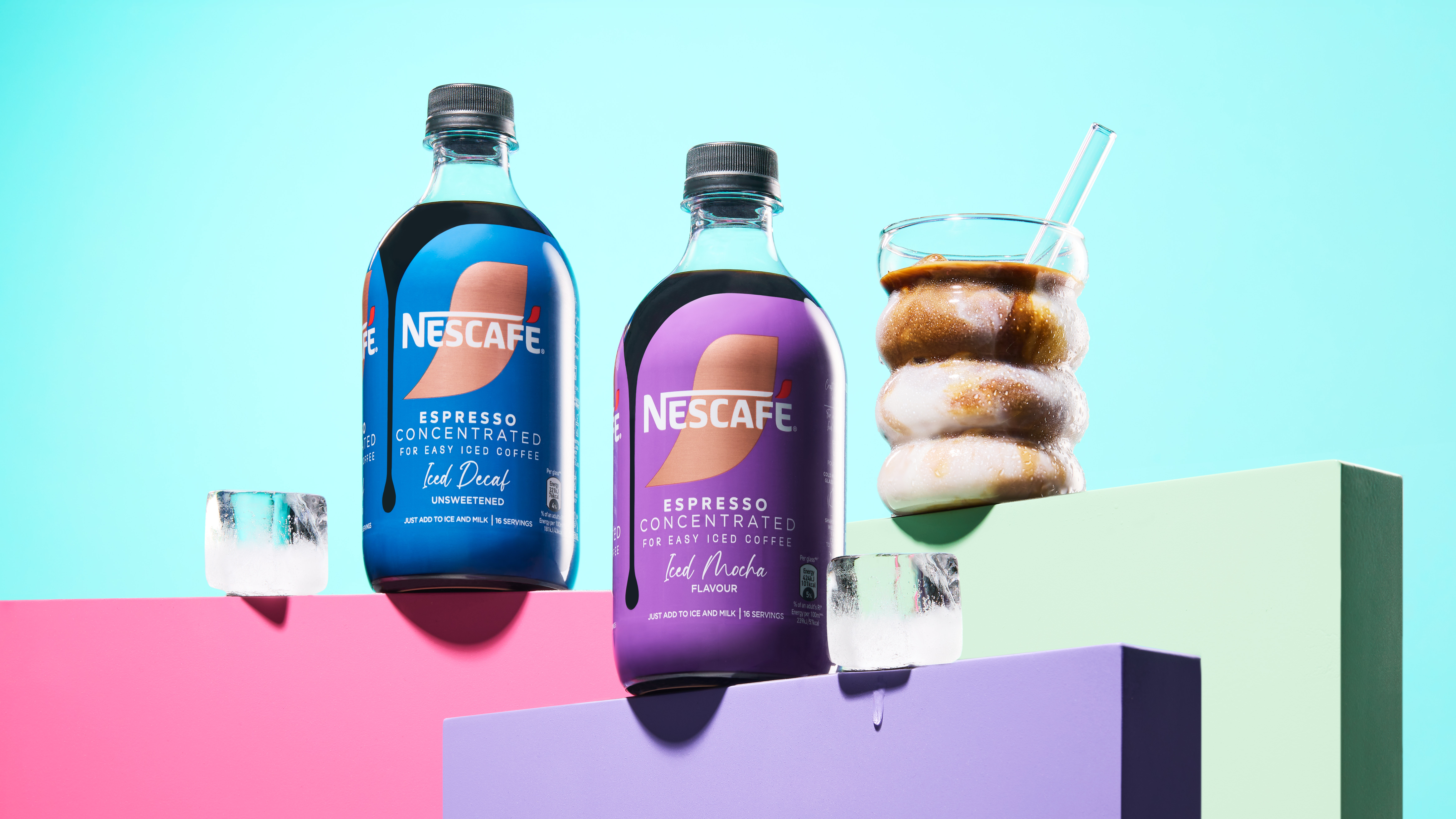 New Variants, Mocha and Decaf sitting on multi-coloured plinths next to ice cubes and a glass of coffee