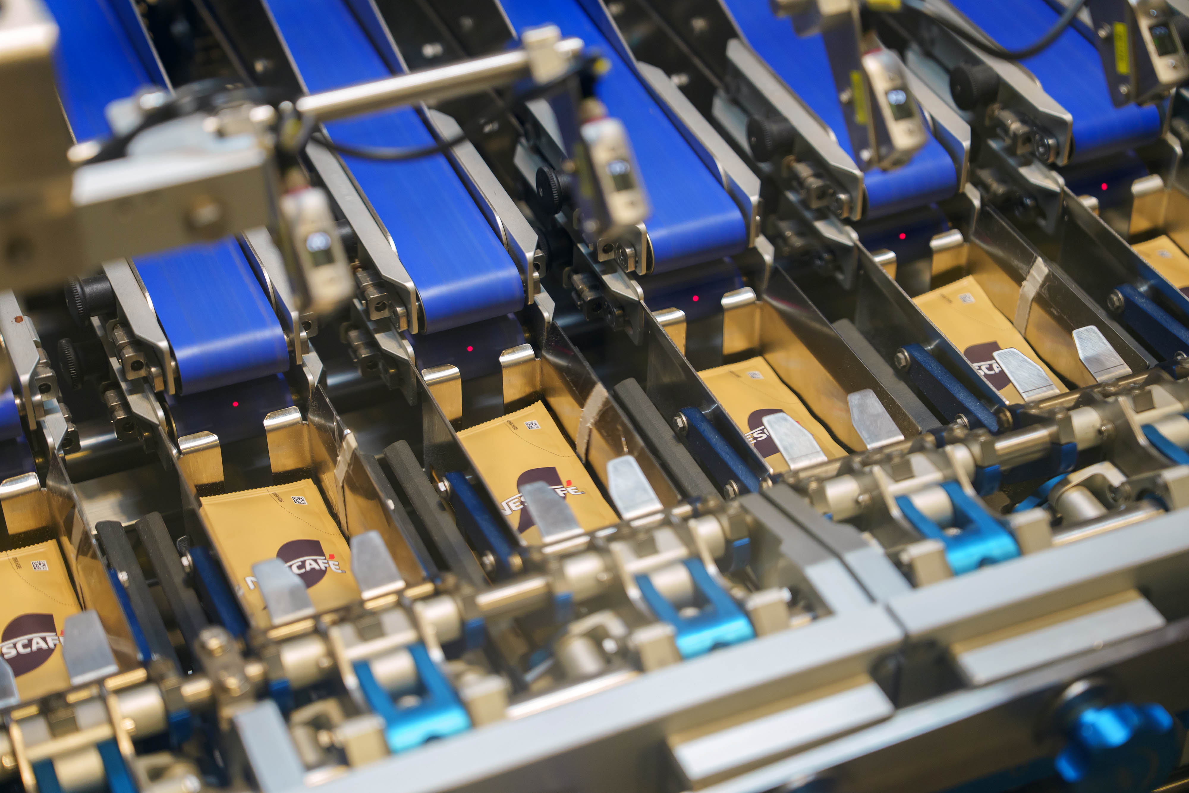 A landscape image of a Nescafé sachet machine