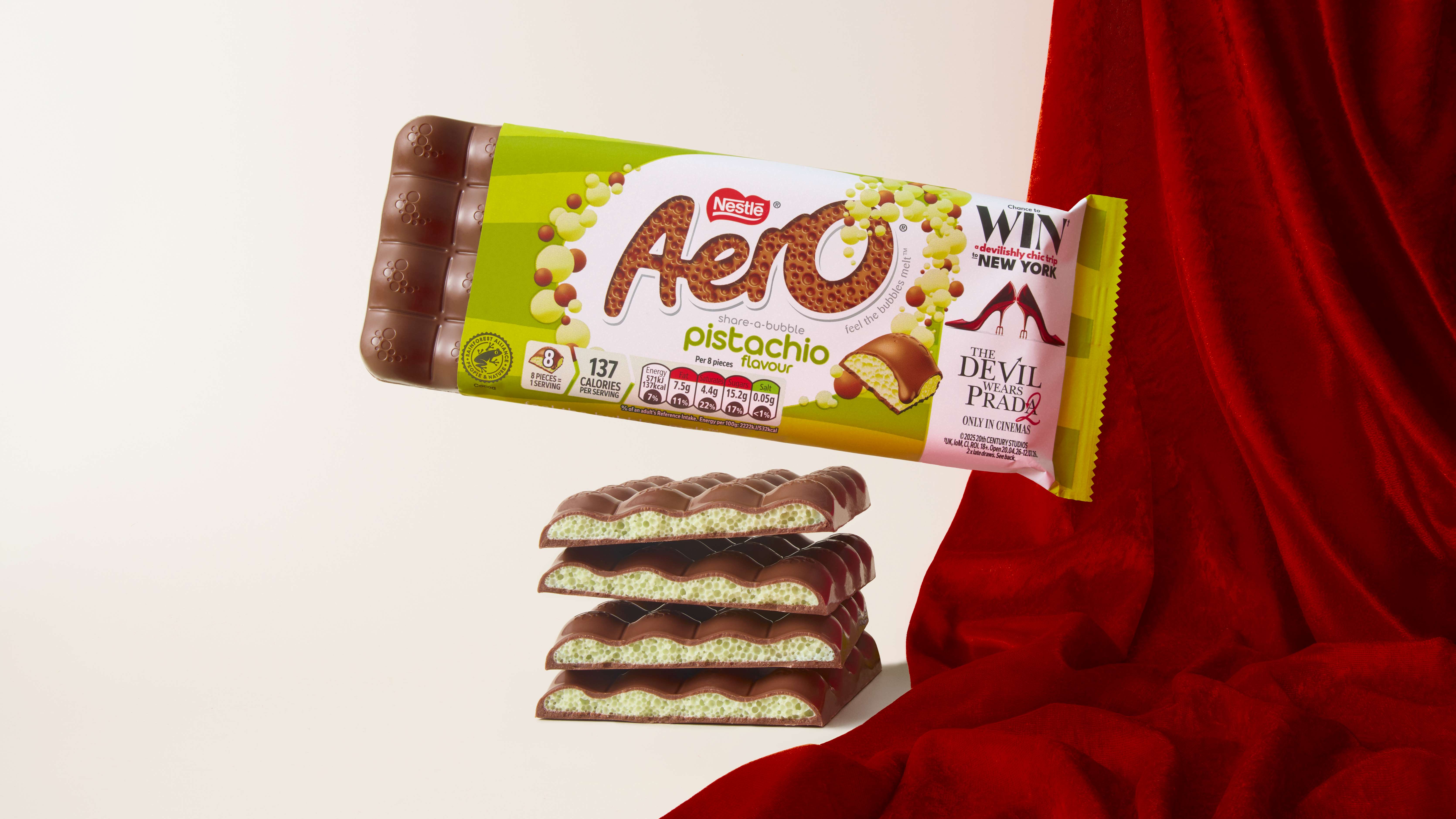 Aero Pistachio on top of Aero chocolates with a white backdrop and red curtain 
