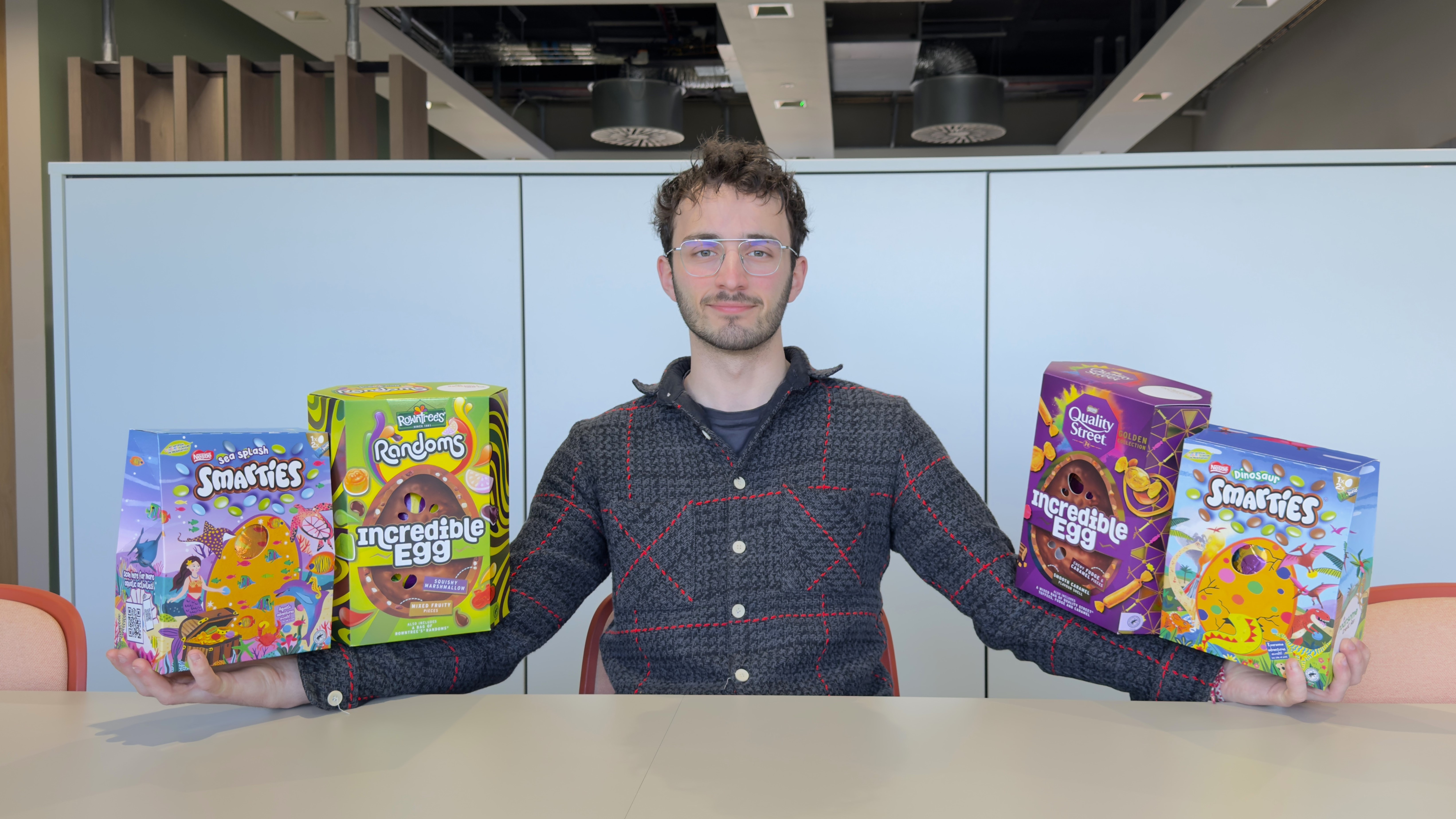Man balancing two Easter eggs along each arm.