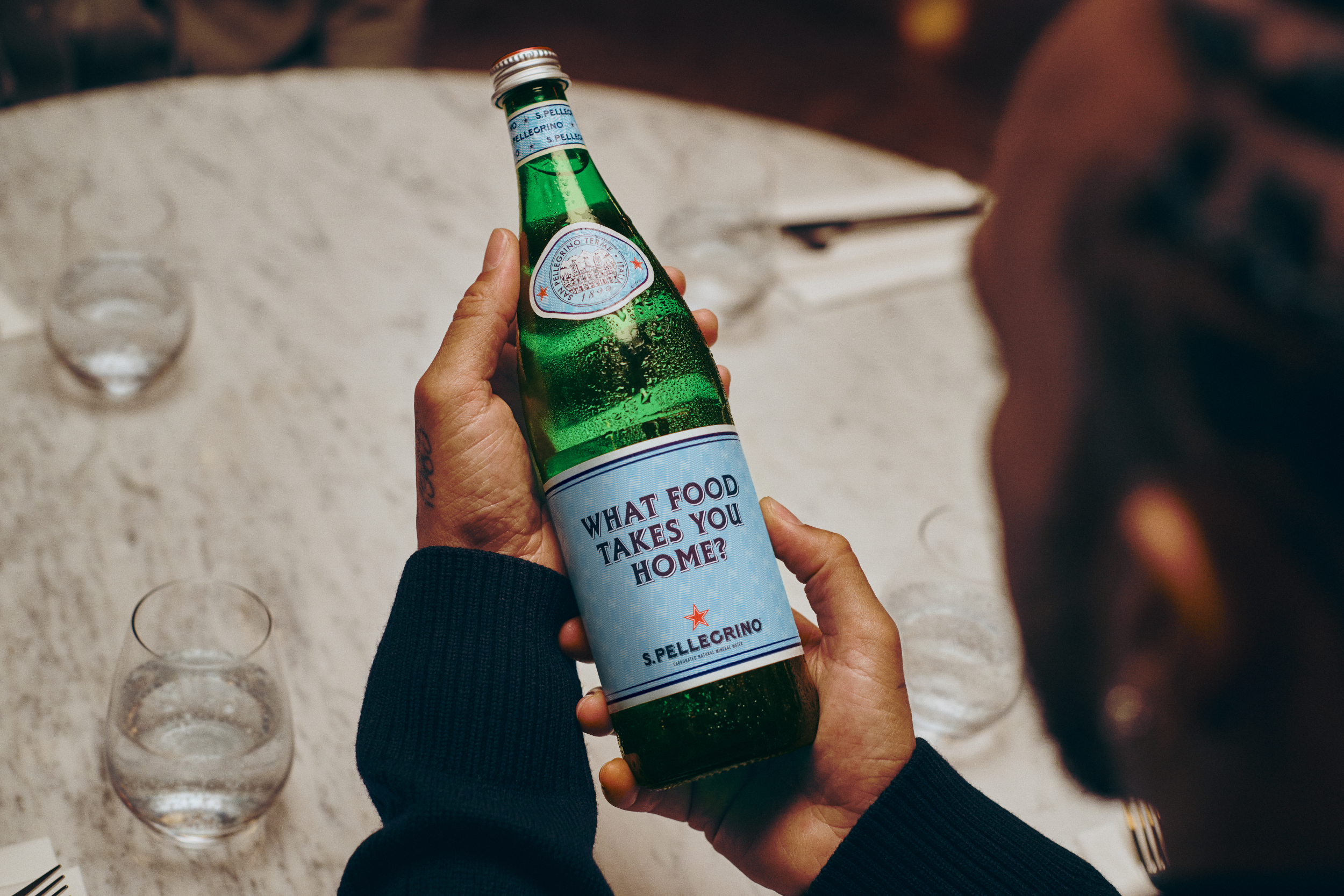 Lewis Hamilton holding bottle of S.Pellegrino