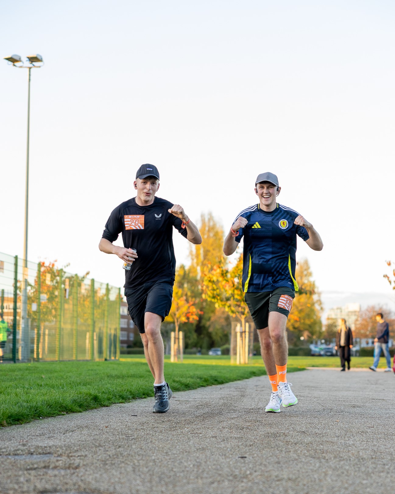 Two men running side by side.
