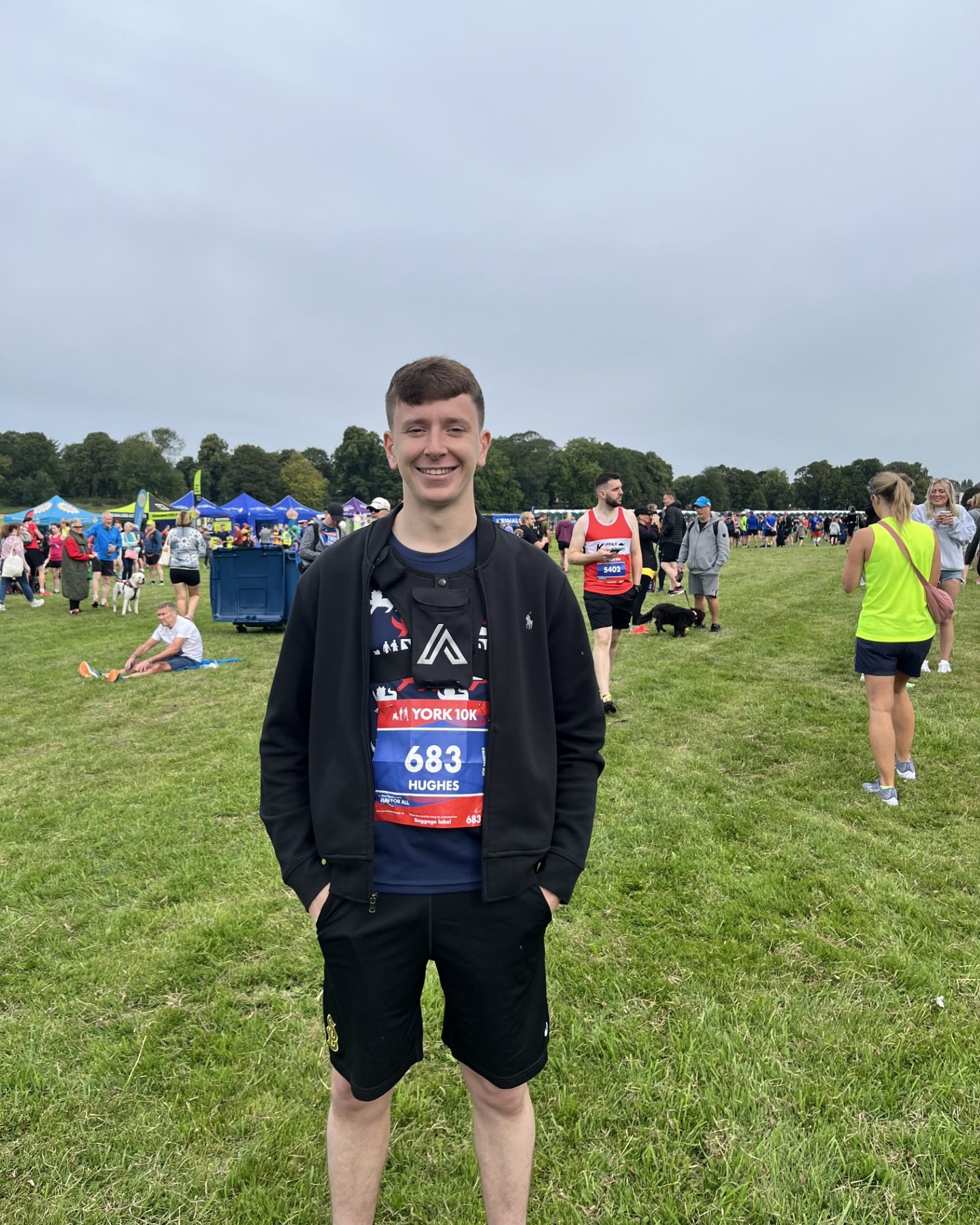 Man standing in field during race day.