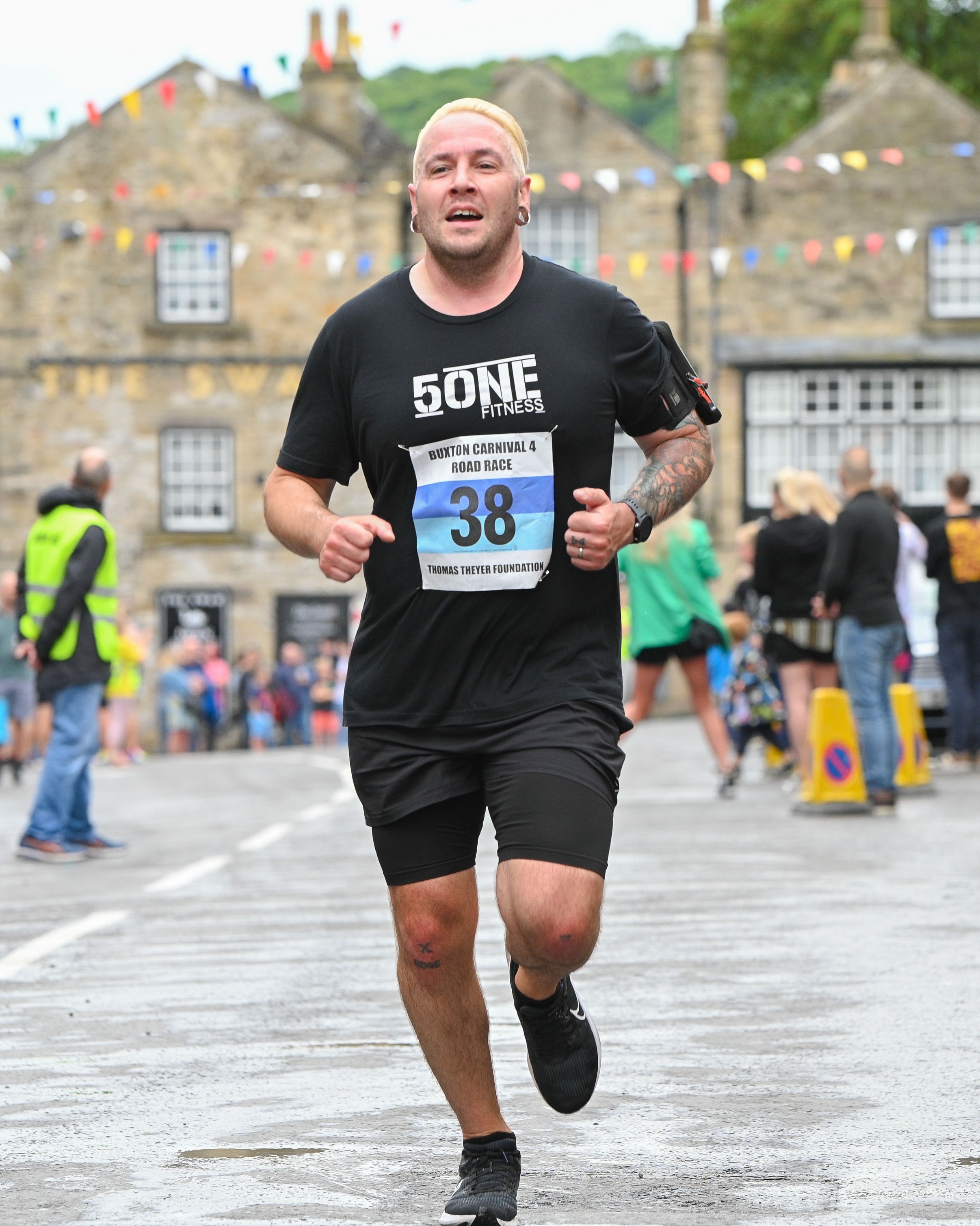 Man in athletic clothing running in a race.