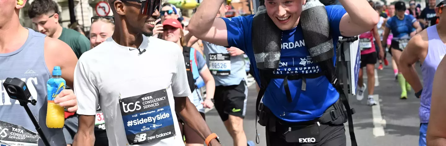 Sir Mo Farrah cheering and giving water to Marathon runners