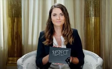 Woman holding a card with word 'respect'