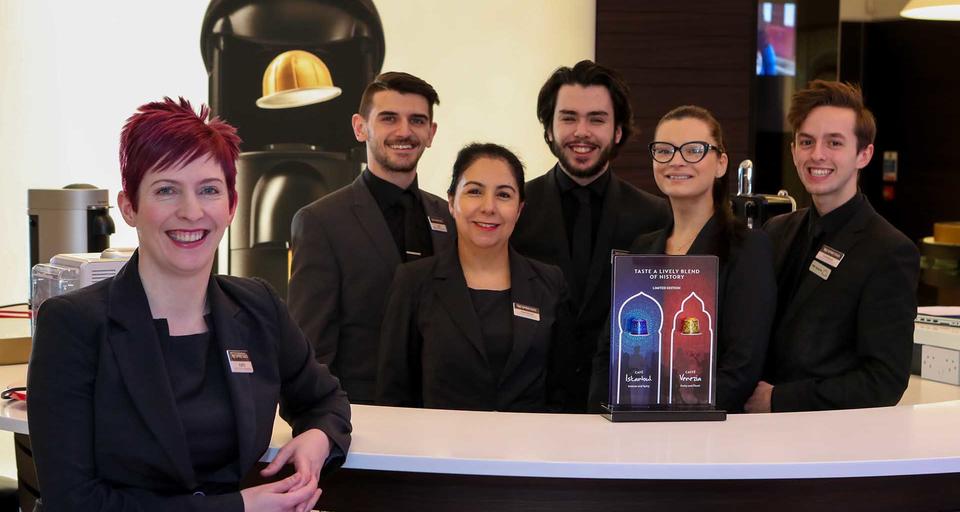 a lady and her team in a nespresso boutique