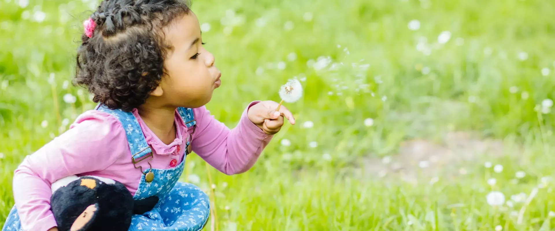 Little girl playing in field