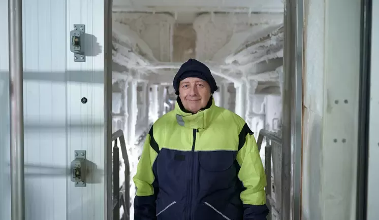 Man wearing a coat inside a freezer