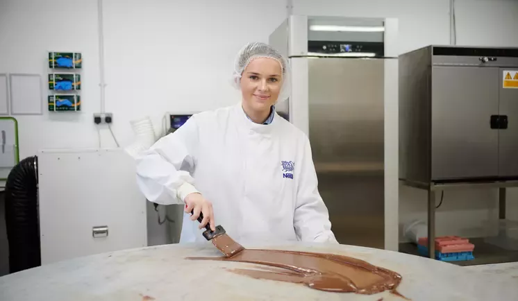 woman with spatula spreading chocolate