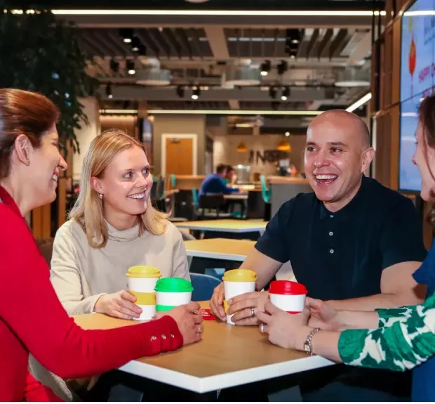 Team drinks coffee in cafe