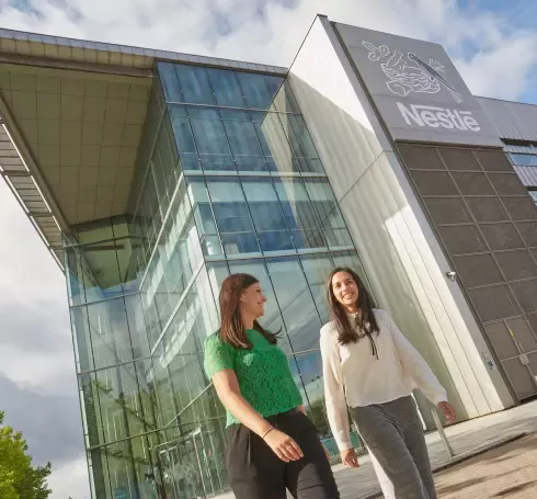 Nestle office behind the walking two women