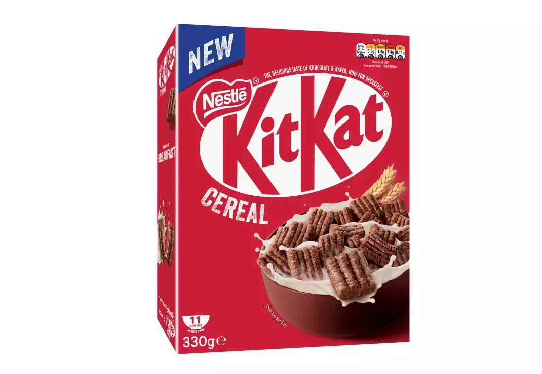 KitKat Cereal comes in a red box with a photo of the new product in a bowl with milk