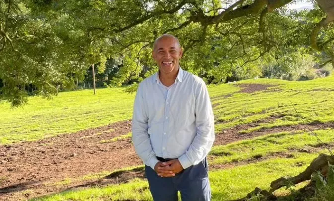 Nestlé's Community Regeneration Lead, Robin Sundaram, stood in a field under a tree