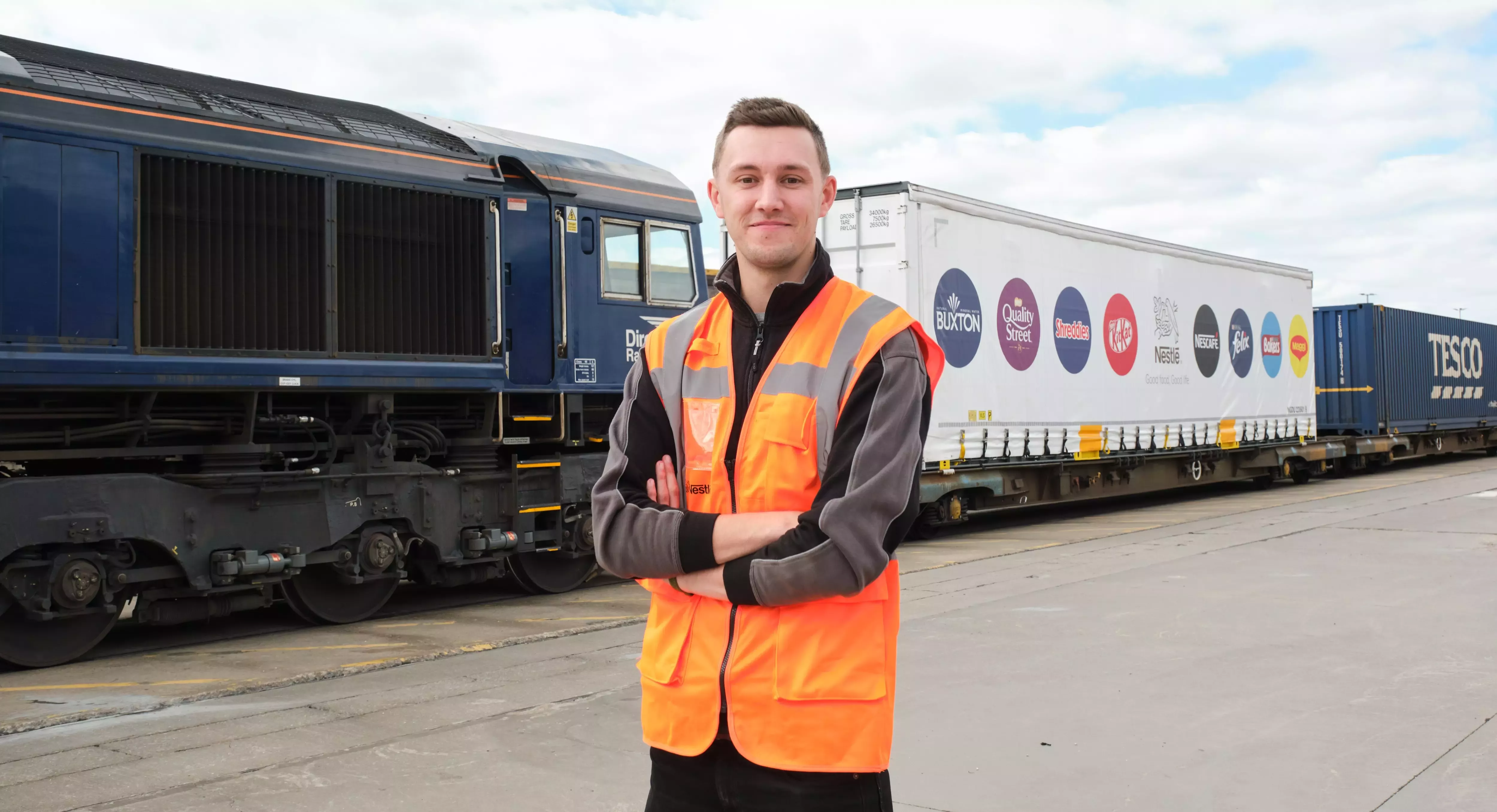 Niall, standing in front of a Tesco train with a Nestlé container on it.