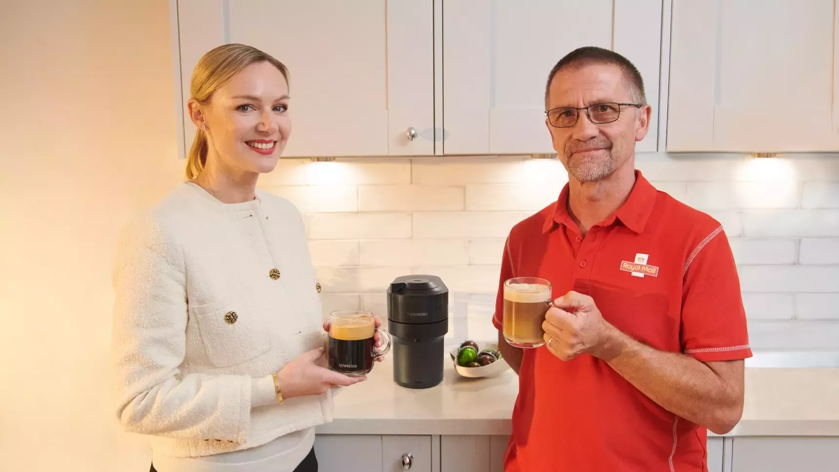 Anna Lundstrom, CEO, Nespresso UK &amp; ROI and Postie Roger Roy from Orpington, Kent  enjoy a Nespresso coffee