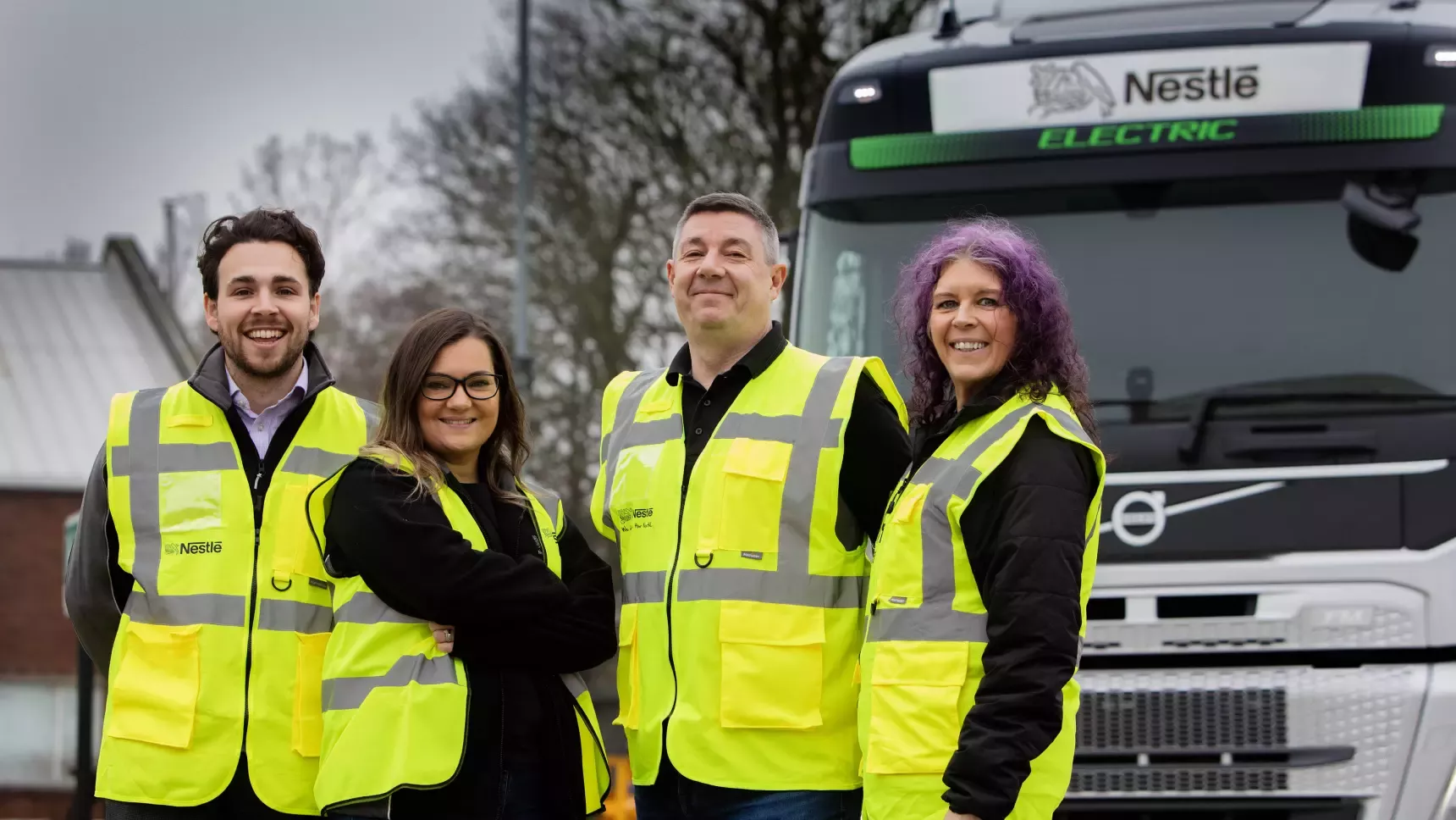 Joe Hurst, Claire Barrass, Dave McGhin and Sally Wright stand in front of the the new BEV truck in high vis jackets