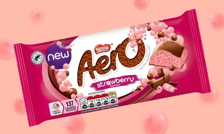 A pink and white package of strawberry flavored candy