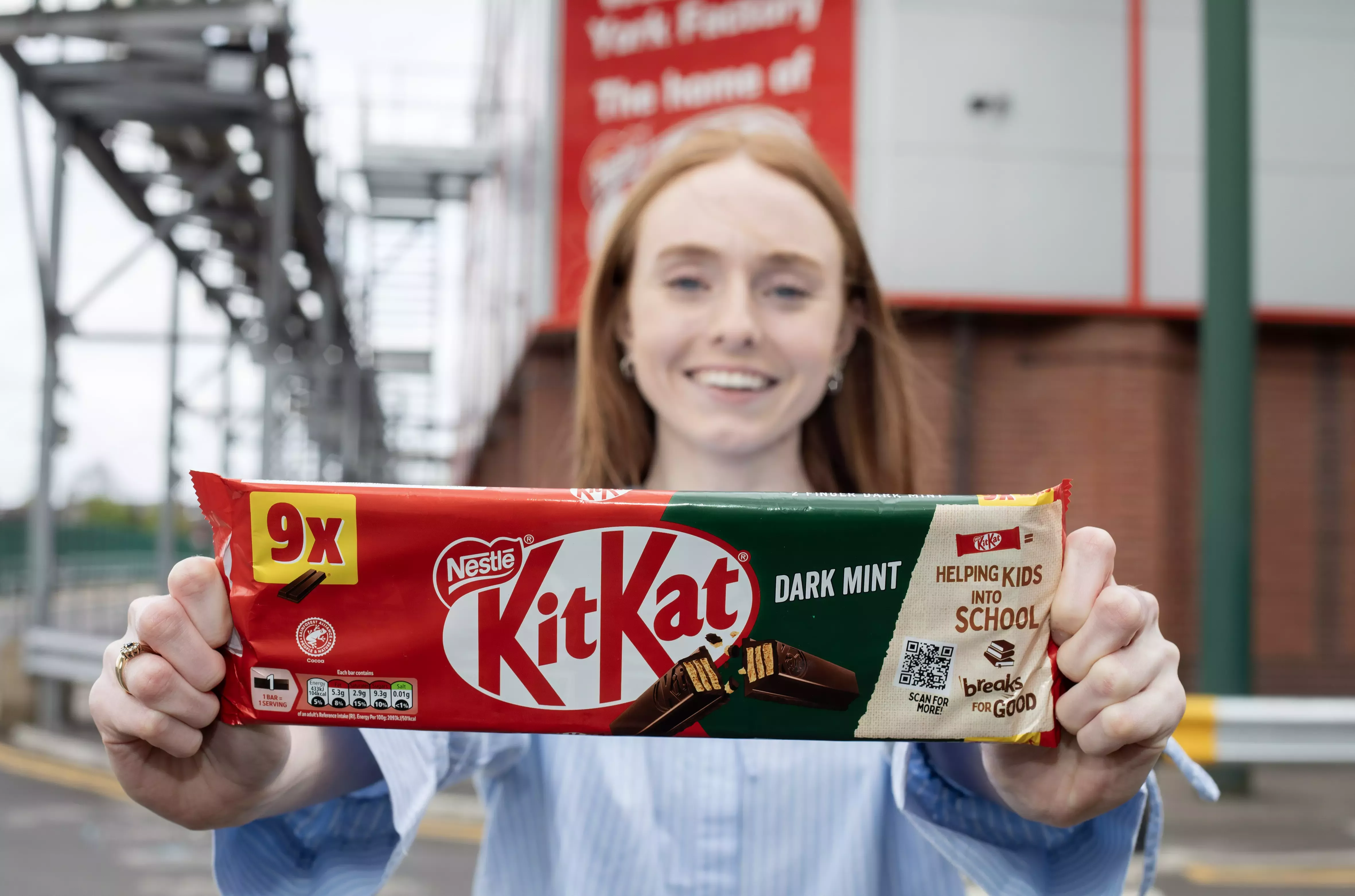 Woman holding a pack of dark mint KitKats