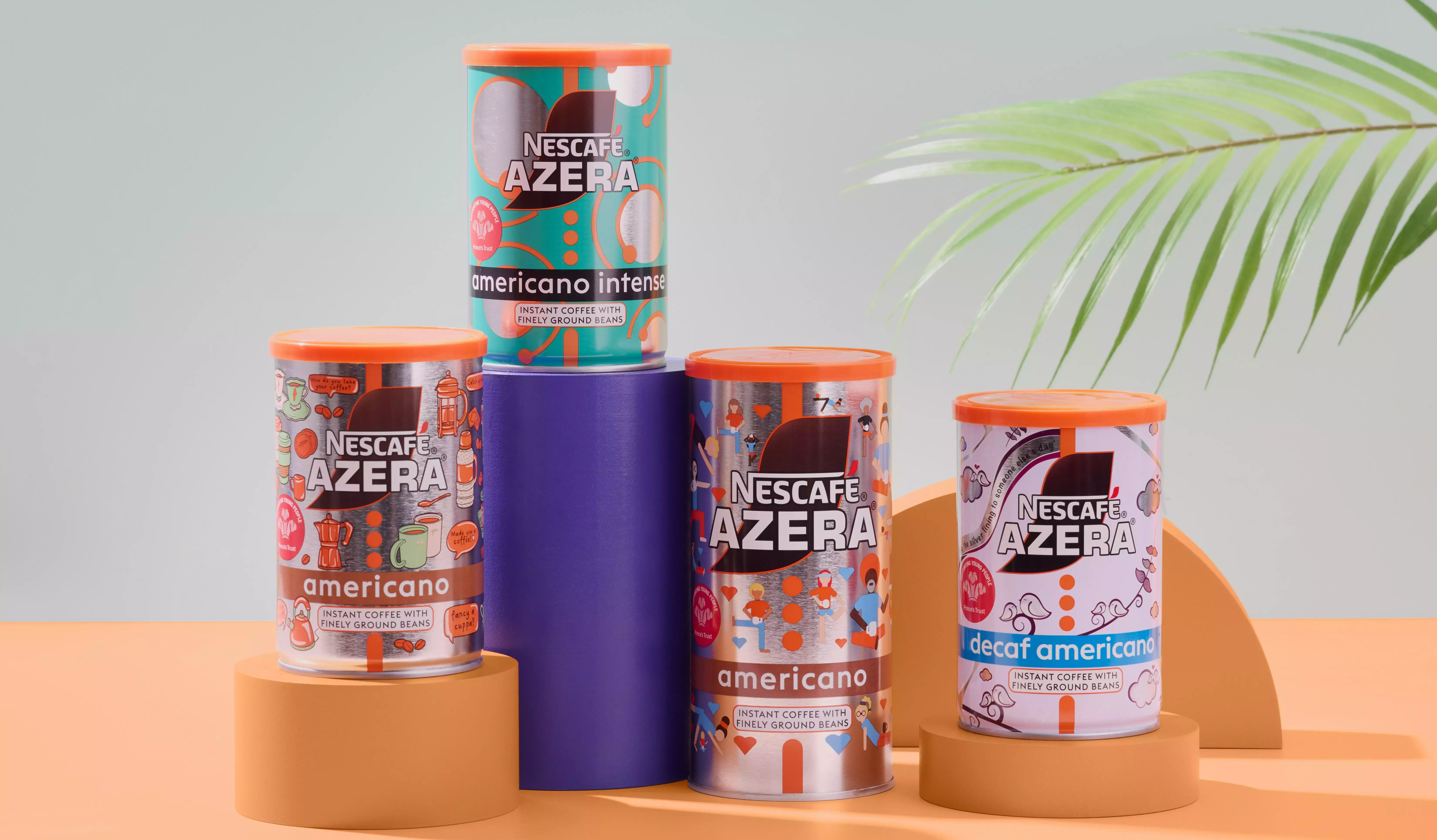 An image of four colourfully designed Nescafé Azera tins, with an orange and grey backdrop with a plant leaf visible.