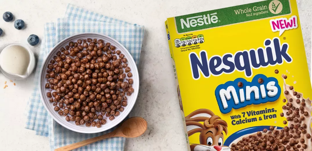 Nesquik minis cereal box and Nesquick minis in a bowl with milk on a table