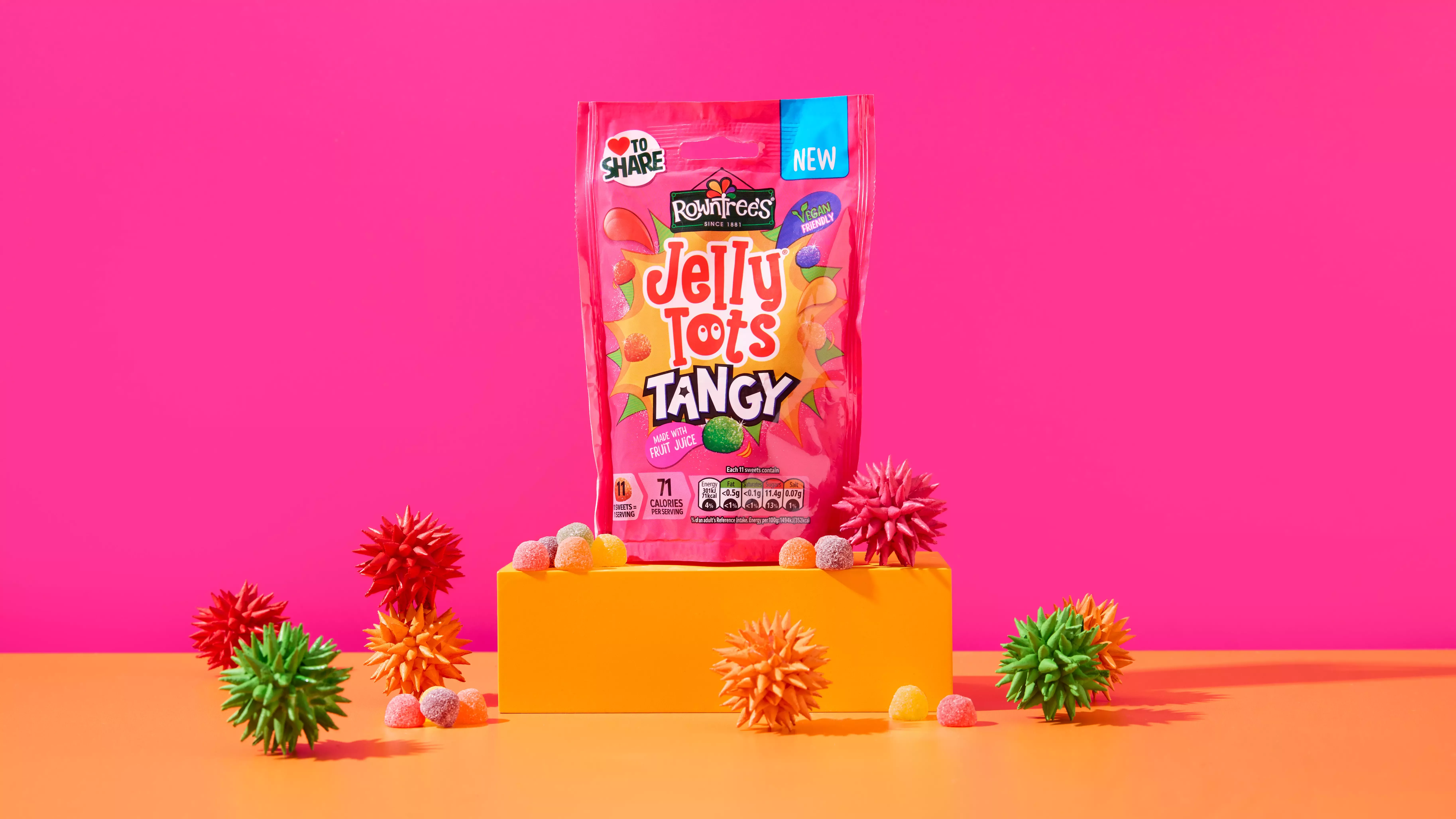 Jelly Tots Tangy on a orange step in front of a pink background