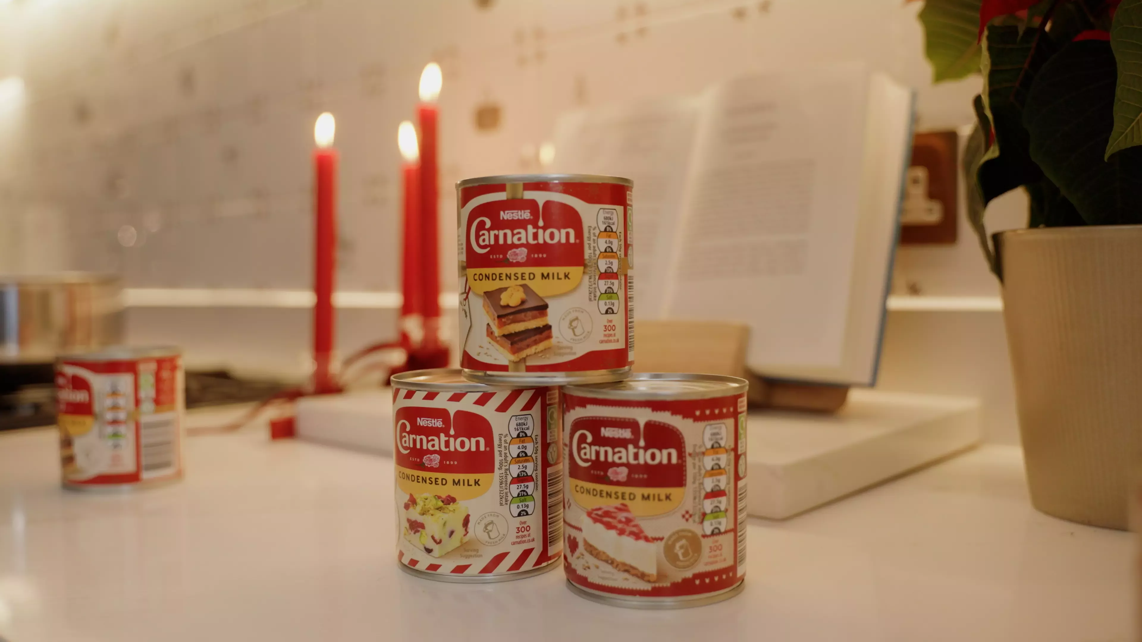 Three Carnation tins on a countertop
