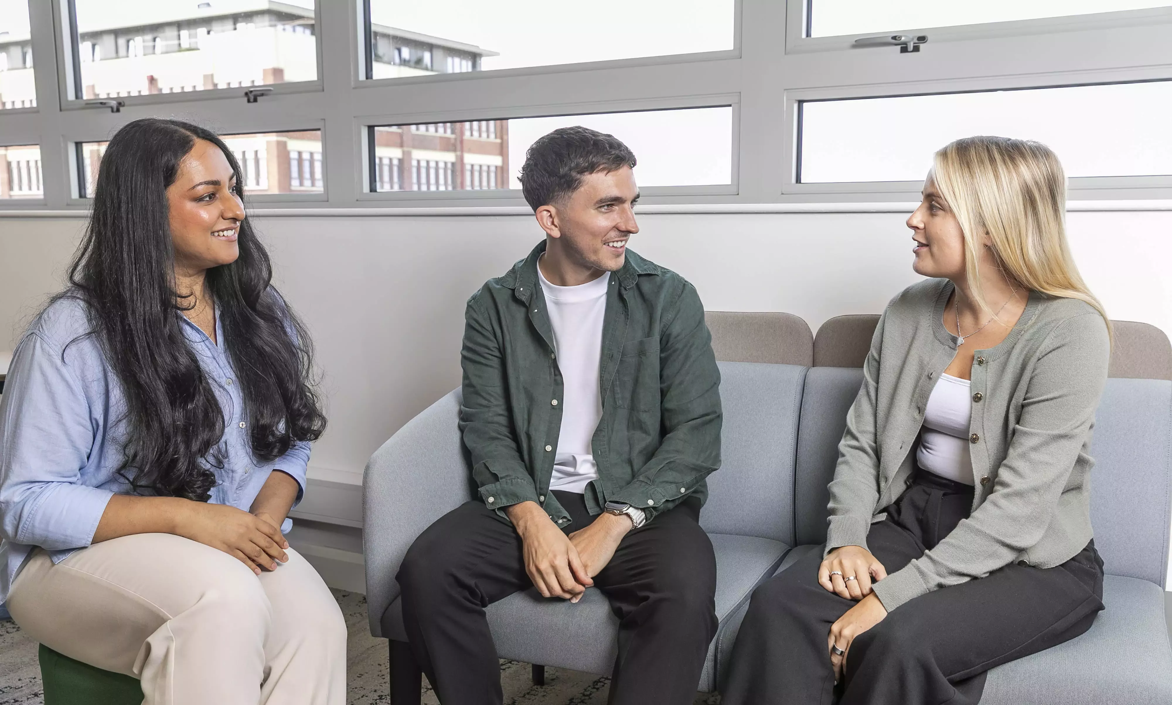 Three people sitting and chatting