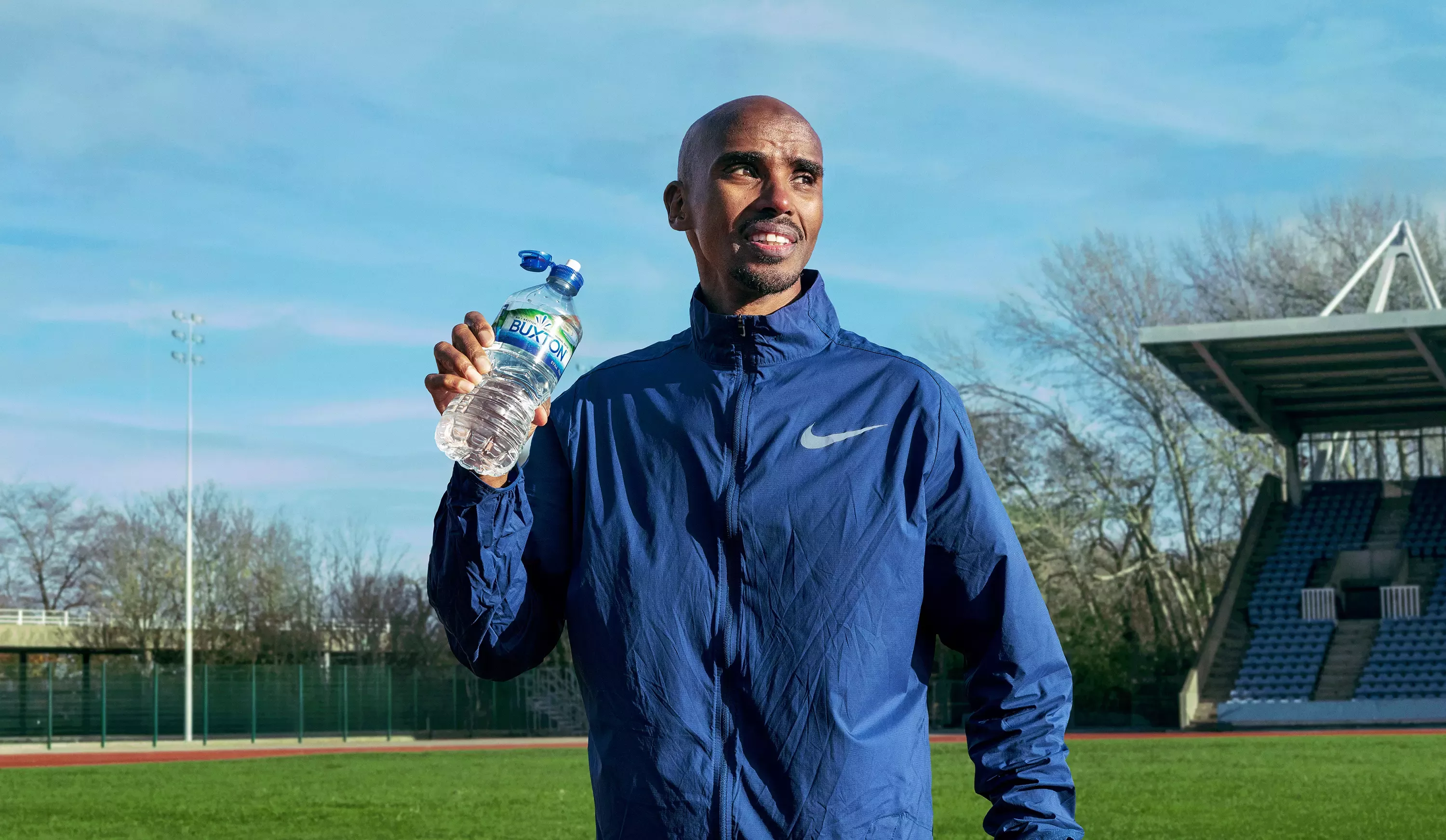 Mo Farah drinking a bottle of Buxton water