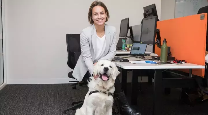 woman with dog at her work desk