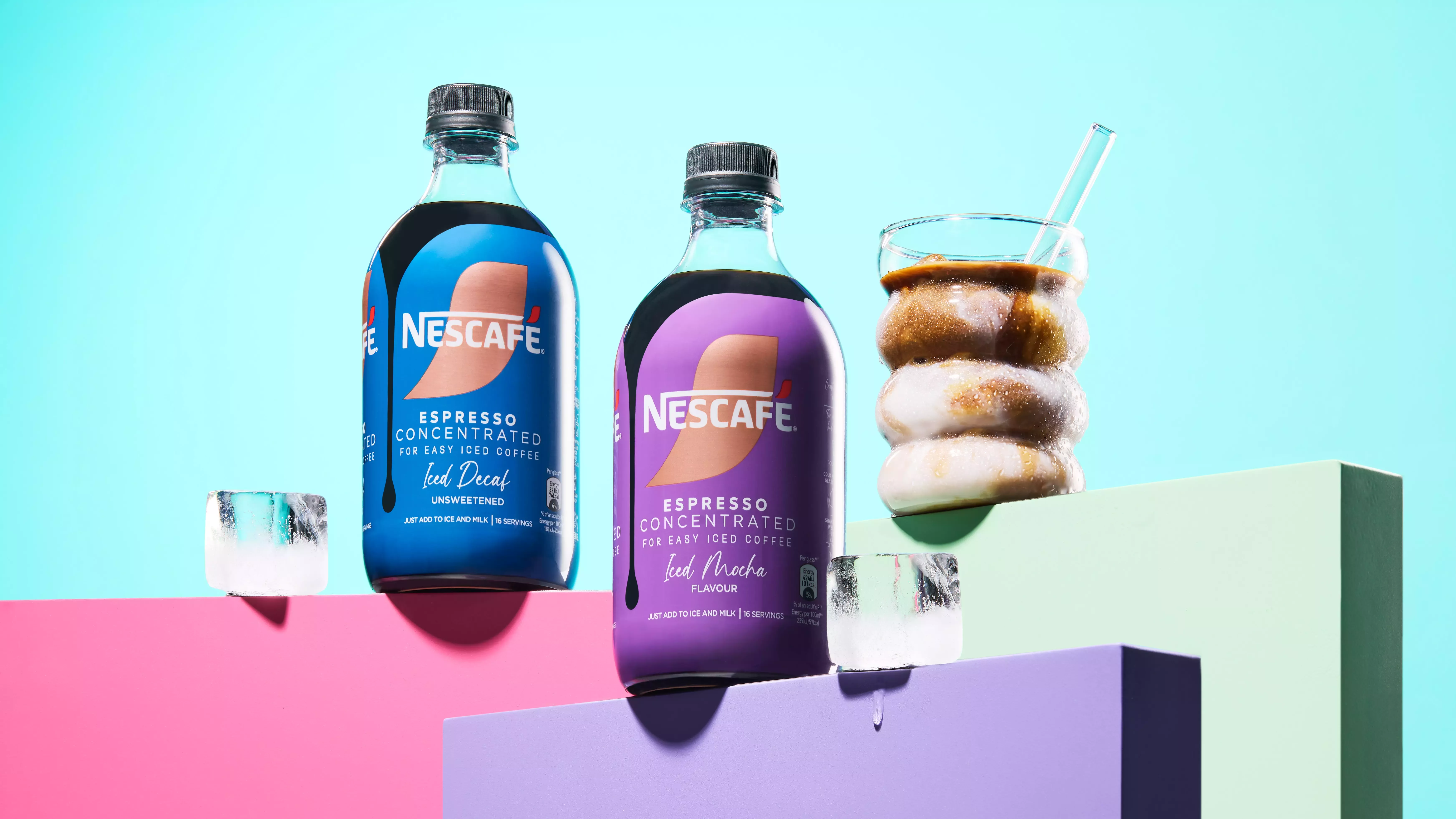 New Variants, Mocha and Decaf sitting on multi-coloured plinths next to ice cubes and a glass of coffee