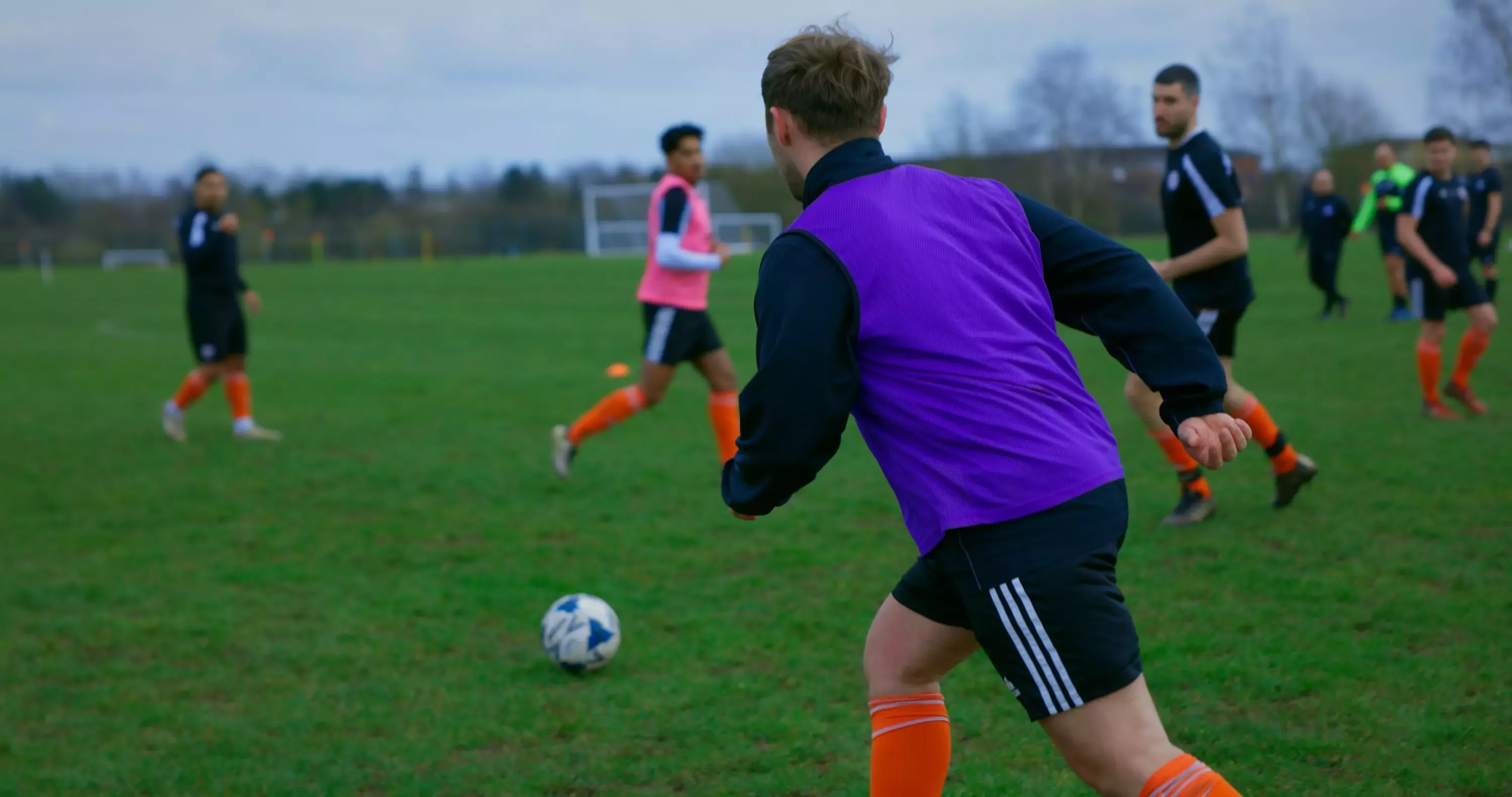 Footballers playing on a pitch