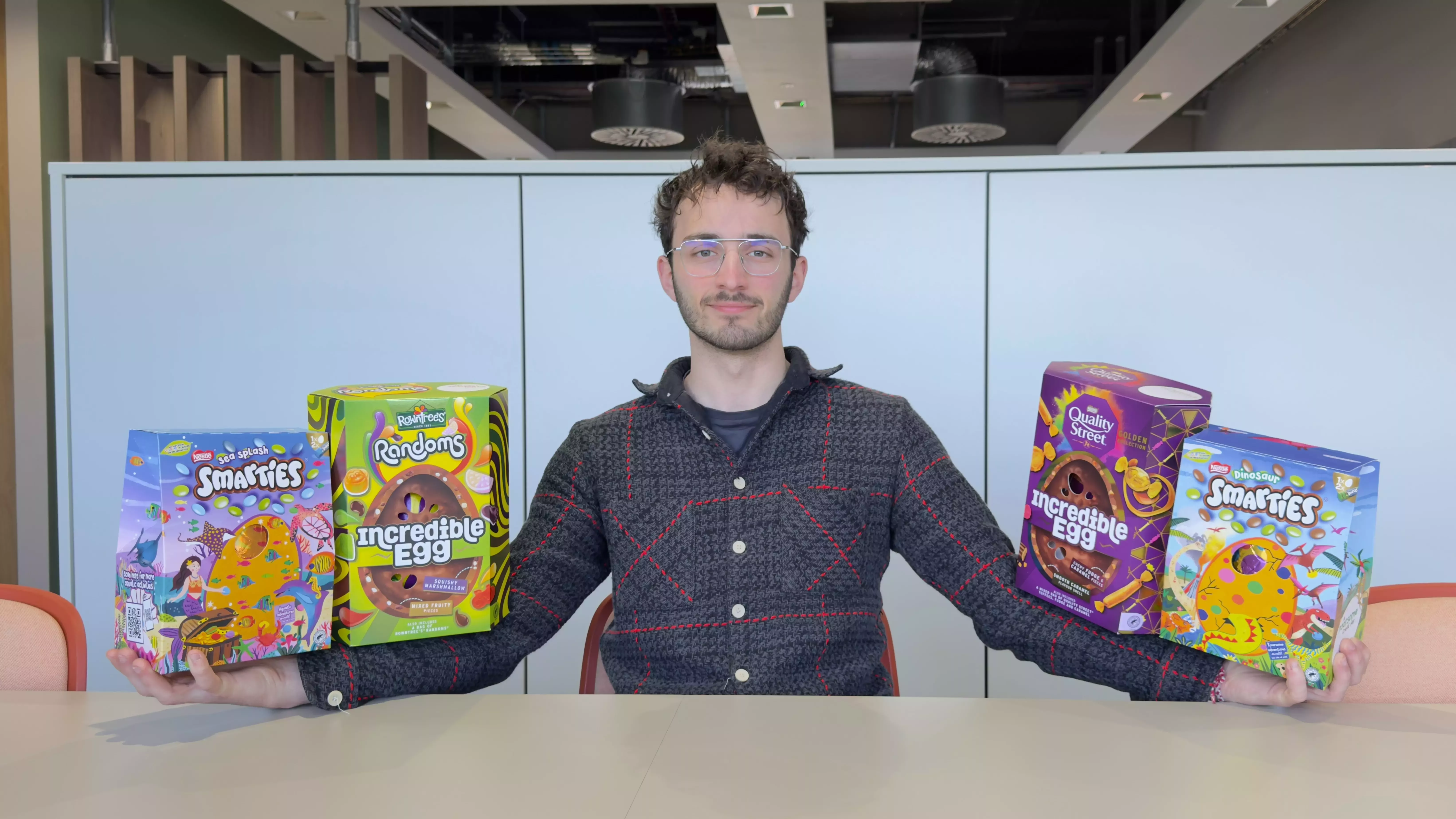 Man balancing two Easter eggs along each arm.