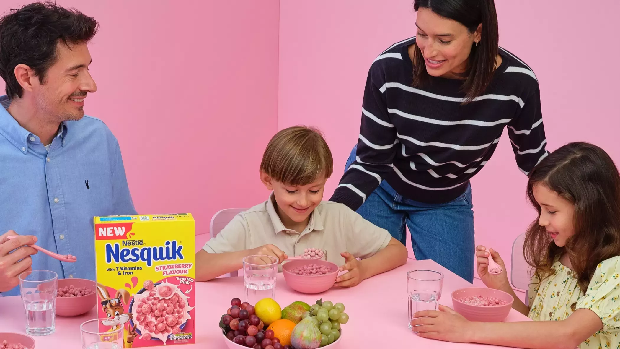 Family at the pink café having a bowl of Nesquik strawberry cereal