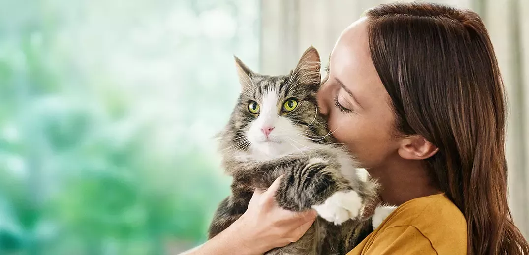 Girl hugging cat